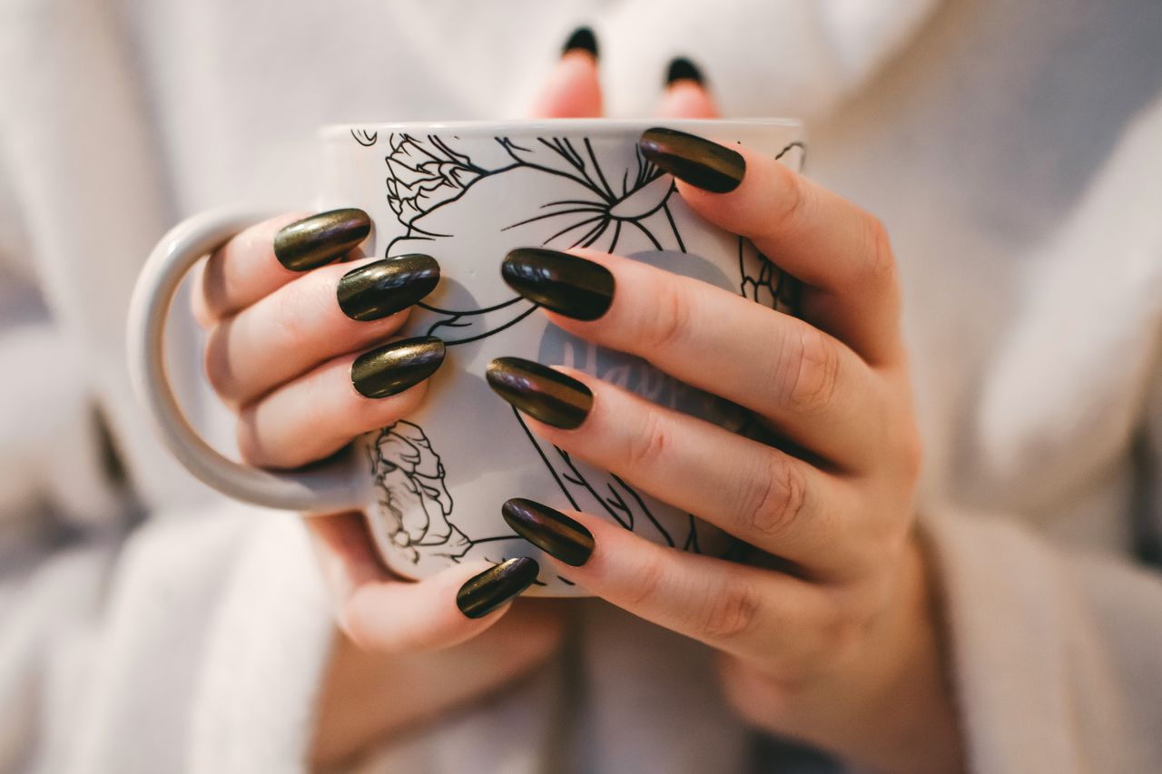 services-02 A close-up of manicured hands holding a decorative mug, perfect for lifestyle and coffee themes.